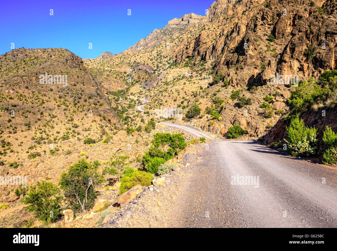 A dirt road through Al Hajar mountains in Oman Stock Photo