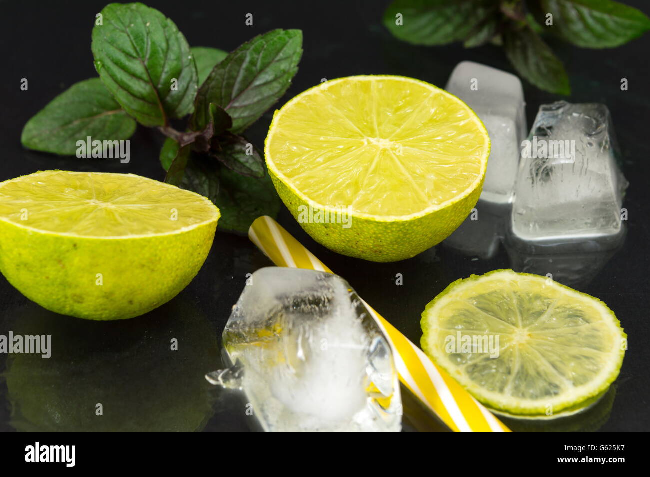 Cold green lime fruit with ice cubes ready for coktail making Stock Photo