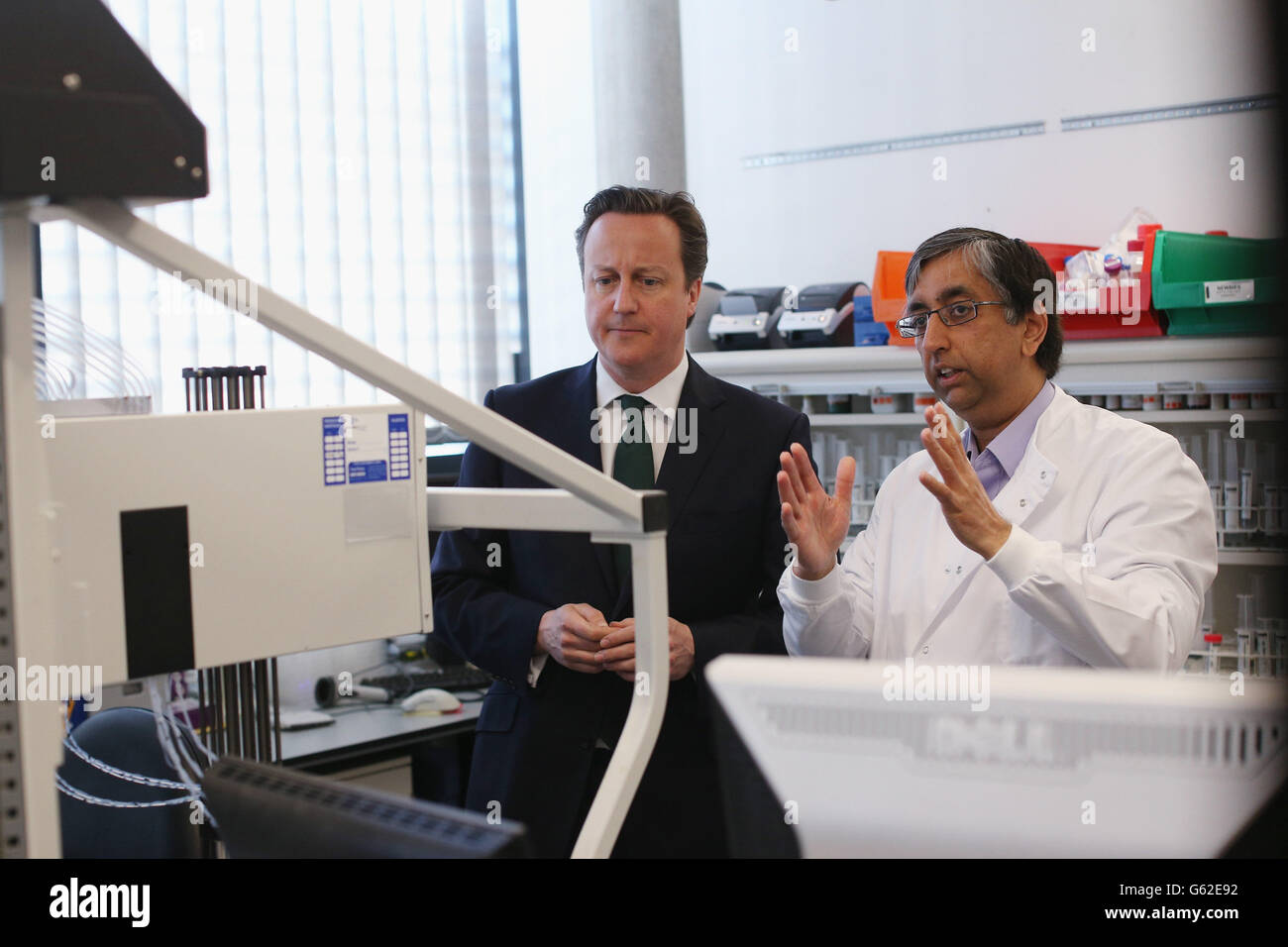 Prime Minister David Cameron (L) speaks with scientists before opening the 'Li Ka Shing Centre for Health Information and Discovery' at Oxford University. Stock Photo