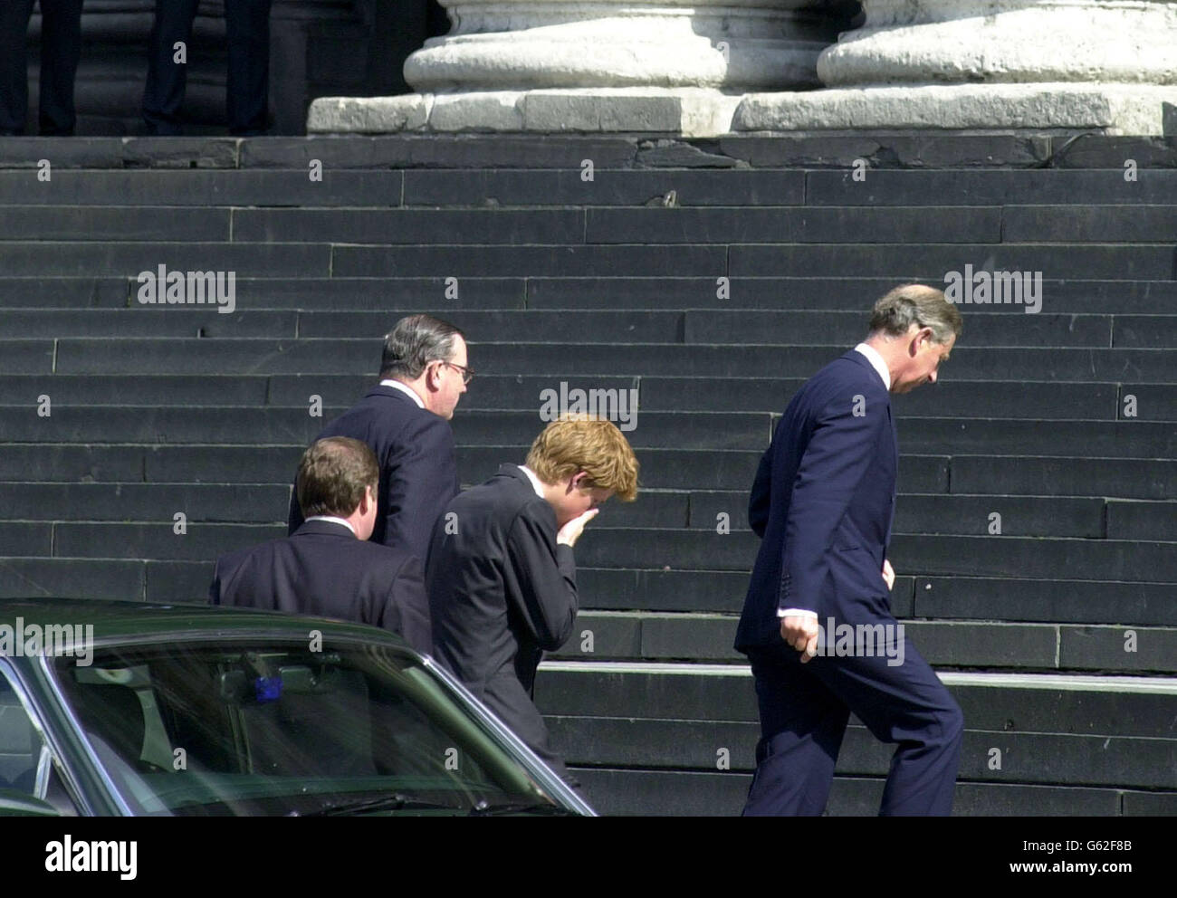 The Prince of Wales (R) and Prince Harry (C) make their way up the steps of St Paul's Cathedral in the City of London. White rose petals representing those who died in terrorist attacks on America were released during the service of Remembrance. *... Afterwards, the Prince of Wales and Prince Harry met relatives of the 67 British victims. Stock Photo