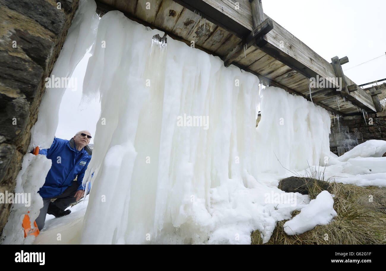 Geoff Lee from Killhope mine Durham Dales takes a look at the ice wall which has formed after recent freezing temperatures. Stock Photo
