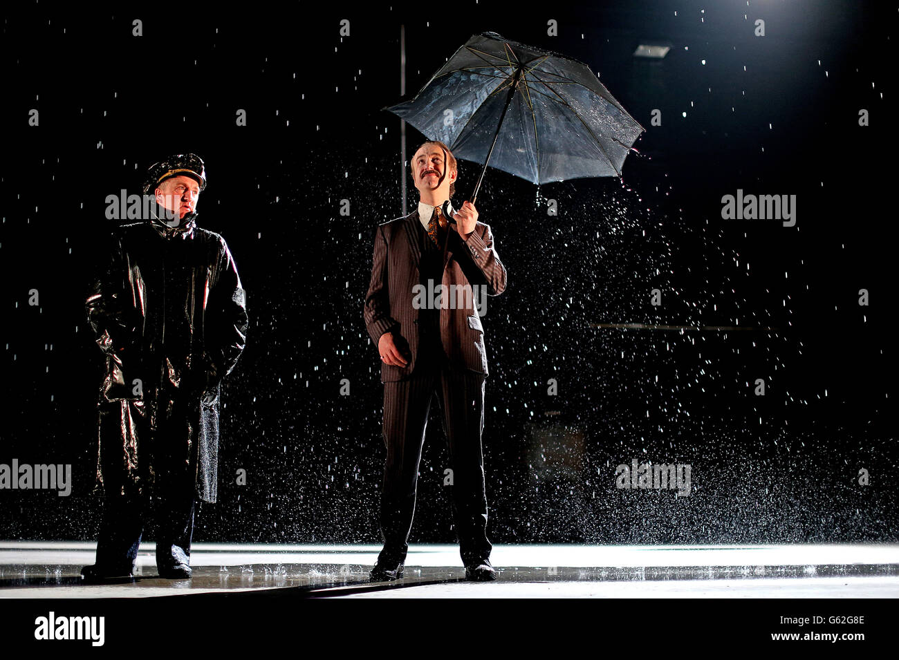 Actors Gary Lydon playing a New York Police Chief (left) and Decaln Conlon as the lead Gangster during a rain shower on stage at the Abbey Theatre in Dublin during rehearsals for Drum Belly, a new play by writer Richard Dormer which has it's world premiere tomorrow night. Stock Photo
