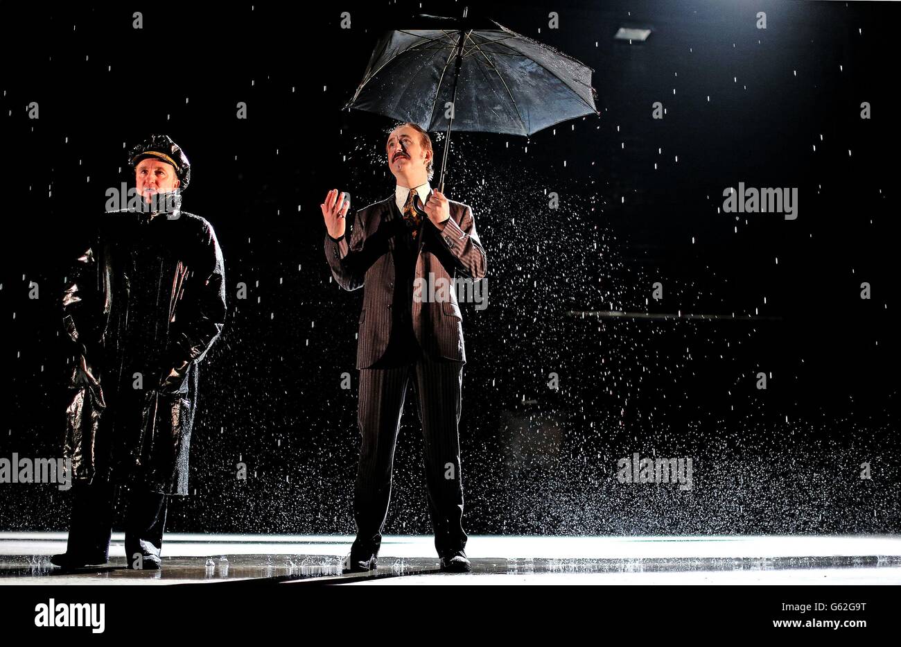 Actors Gary Lydon playing a New York Police Chief and Declan Conlon as the lead Gangster during a rain shower on stage at the Abbey Theatre in Dublin during rehearsals for Drum Belly, a new play by writer Richard Dormer which has it's world premiere tomorrow night. Stock Photo
