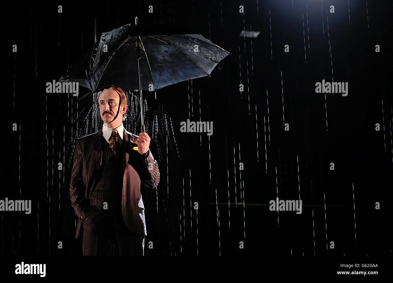 Actor Declan Conlon as the lead Gangster during a rain shower on stage at the Abbey Theatre in Dublin during rehearsals for Drum Belly, a new play by writer Richard Dormer which has it's world premiere tomorrow night. Stock Photo