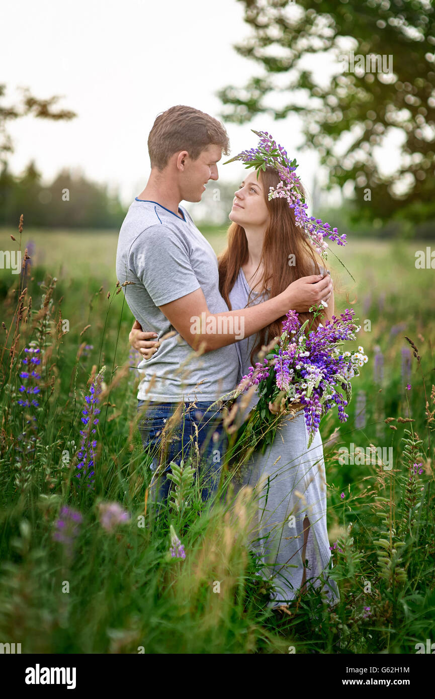 portrait of young stylish fashion couple posing in field Stock Photo