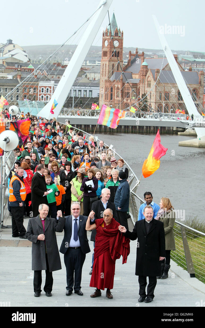 The Dalai Lama crosses the Peace Bridge in Londonderry with Richard Moore (second left) from Children in Crossfire and church leaders Bishop Ken Good (left) and Msgr Eamonn Martin (right). The Dalai Lama was visiting Northern Ireland where he has said there is no alternative to the peace process. Stock Photo