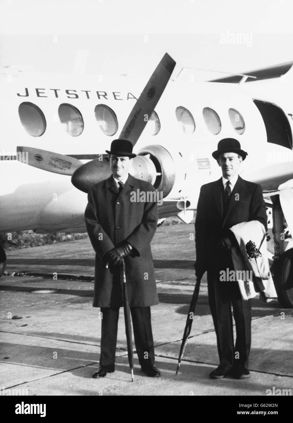 Bowler-hatted Handley Page chief test pilot, J.W. Allam (Johnny), of Fyfield Lodge, Kings Langley, Hertfordshire, and another Handley Page test pilot, G.H. Moreau, of Hartfield Road, Elstree, Hertfordshire, pictured before take-off in Handley Page's first prototype Jetstream - Britain's latest executive and local service transport - from the constructor's Radlett's aerodrome headquarters in Hertfordshire en-route for Pau in south-west France. The Jetsream has travelled to France for certification trials to be undertaken with less risk of inclement weather in France. Stock Photo