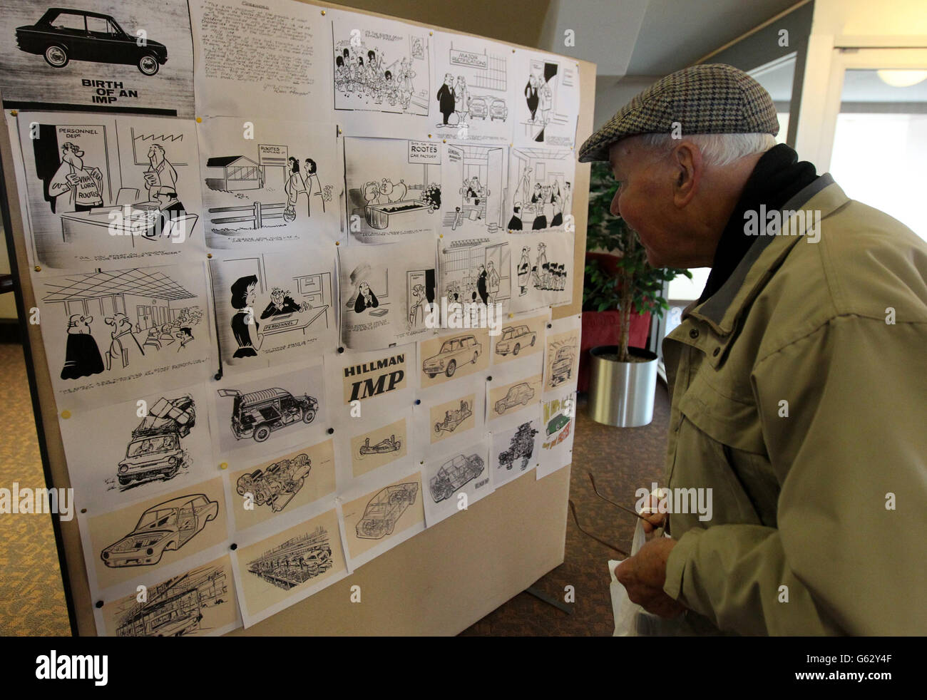 A car enthusiast views drawings of Hillman Imp cars as they prepare to leave by convoy the site of the former factory in Linwood to mark the 50th anniversary of the first of the vehicles made at the Rootes car plant. Stock Photo