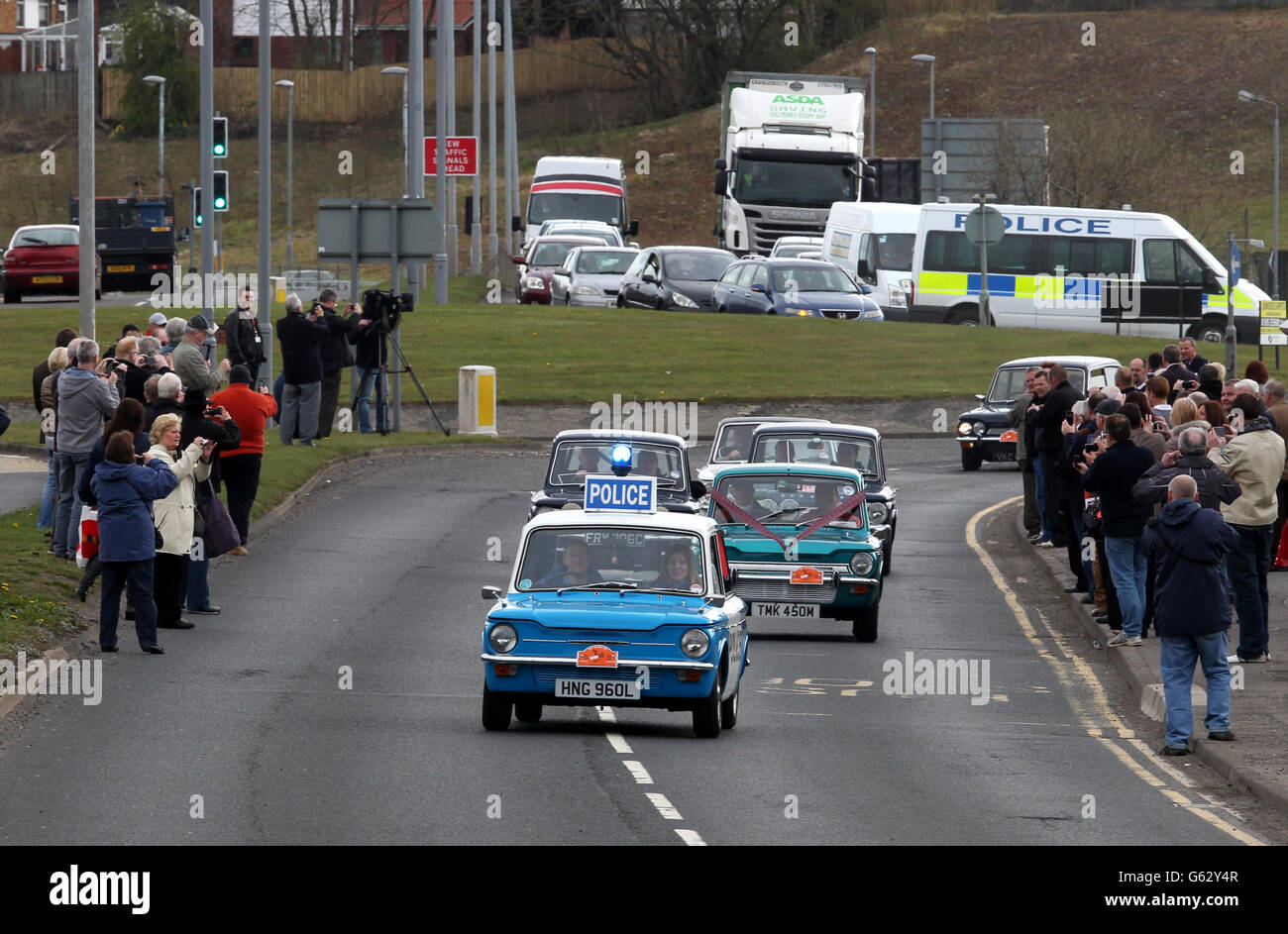 A convoy of Hillman Imp cars as they leave the site of the former factory in Linwood to mark the 50th anniversary of the first of the vehicles made at the Rootes car plant. Stock Photo