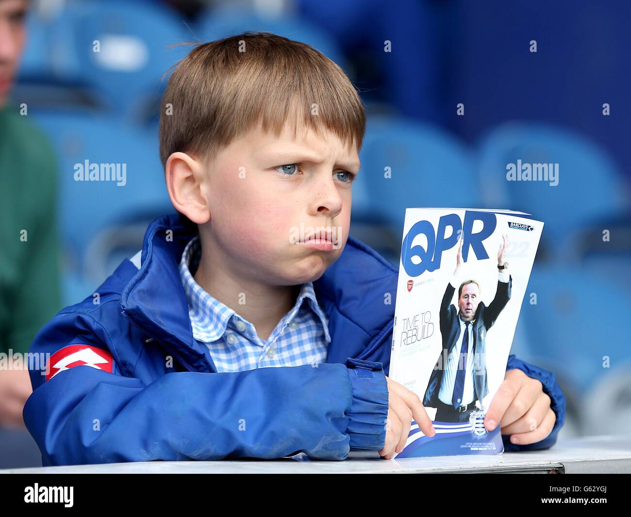 A young Queens Park Rangers fan holds a matchday programme Stock Photo ...