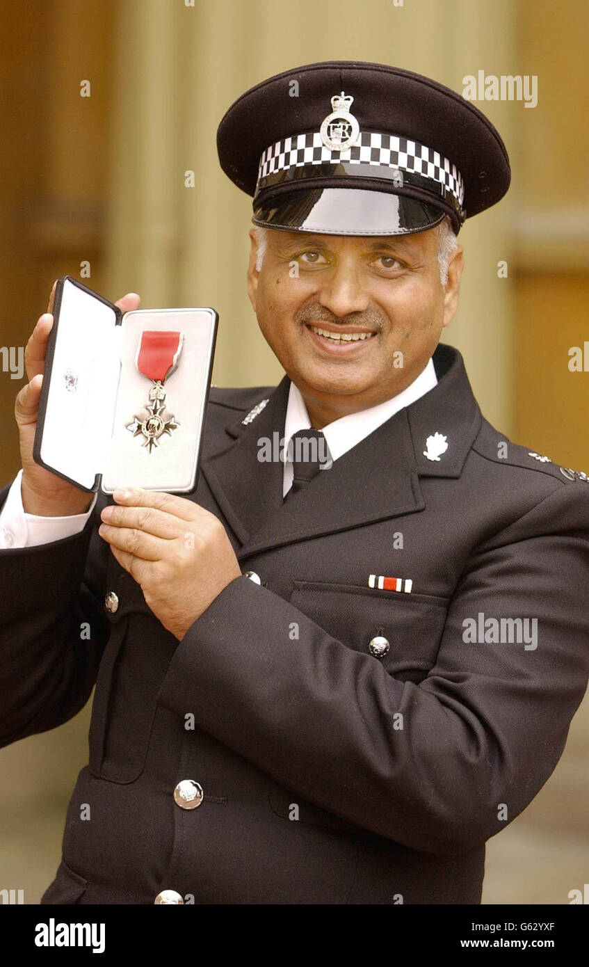Special Constable Mohammed Adris of the West Midlands Police force, holds his MBE outside Buckingham Palace. Stock Photo