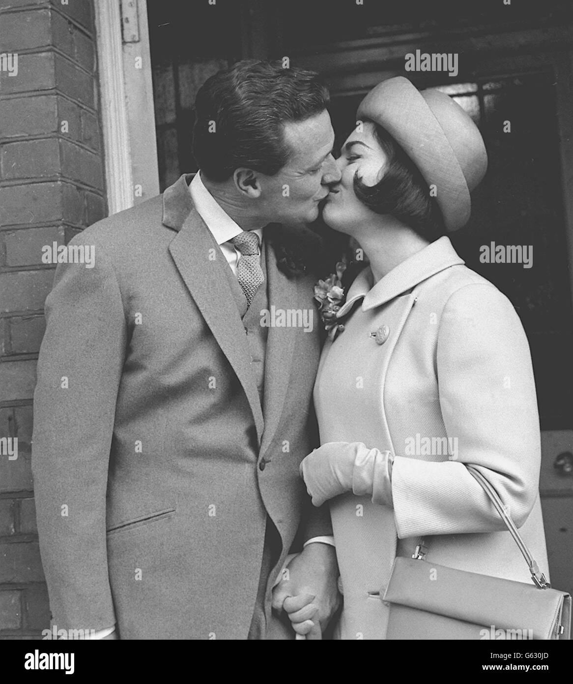 Patrick MacNee kisses his bride Catherine Woodville after their wedding at Hampstead, London