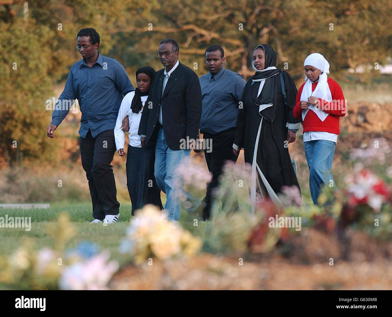 The Osman family - from left: brother Awil, sister Sagal, father Abdul, brqther Bashir, mother Marian and sister Sarah - at the graveside in Watford of 15-year-old Kaiser Osman. * 24/09/02 A 12-year-old boy was cleared, of murdering Kaiser following a three-week trial at the Old Bailey. A 15-year-old, who was 14 when he stabbed the Somali refugee, was cleared of murder but found guilty of manslaughter. Stock Photo