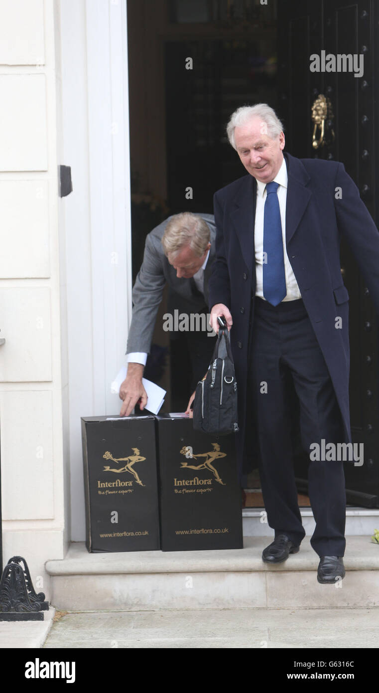 Sir Mark Thatcher (left) takes in flowers just before he leaves the home of his late mother, former Prime Minister Margaret Thatcher in Central London. Stock Photo