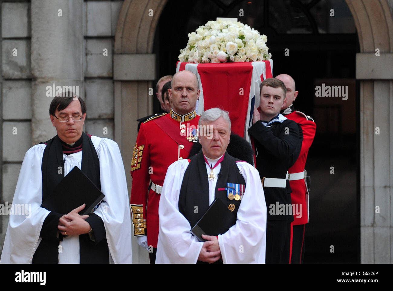 The Bearer Party made up of personnel from the three branches of the military transfer the coffin of former Prime Minister Margaret Thatcher onto a gun carriage to be drawn by the King's Troop Royal Horse Artillery from the Church of St Clement Danes to her funeral service, at St Paul's Cathedral, central London. Stock Photo
