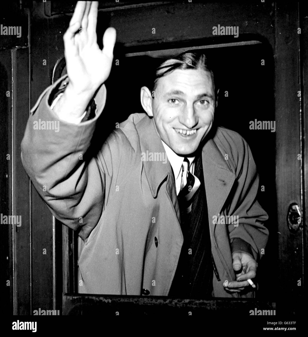 For the third time since the war a M.C.C. team left for a Test tour, this time against South Africa. Len Hutton, the Yorkshire player, waving a cheery farewell from the boat-train at Waterloo station before the M.C.C. Team left for Southampton. Stock Photo