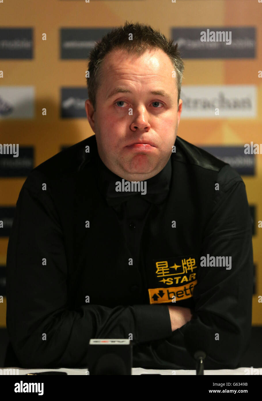 Scotland's John Higgins speaks to the media after his first round match defeat 10.6 against England's Mark Davis, in the Betfair World Championships at the Crucible, Sheffield. Stock Photo