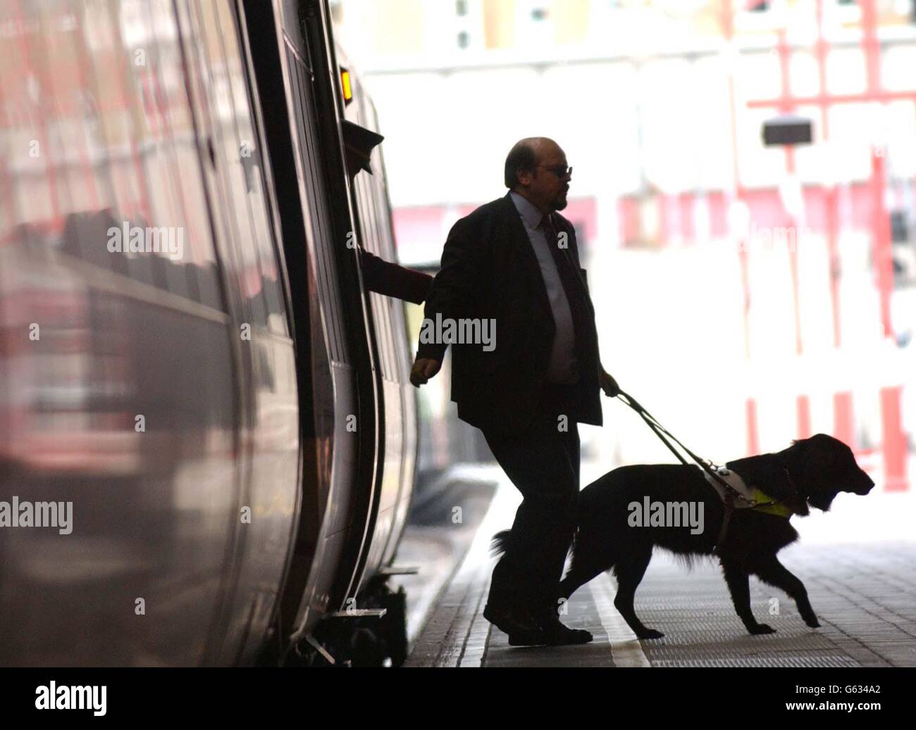 Roger Bailey and his guide dog Jess, disembark a train at London's Marylebone Station, during a photocall to launch the 'Access for All' Campaign by The Guide Dogs for the Blind Association, which aims to make it easier for disabled people to use public transport. Stock Photo