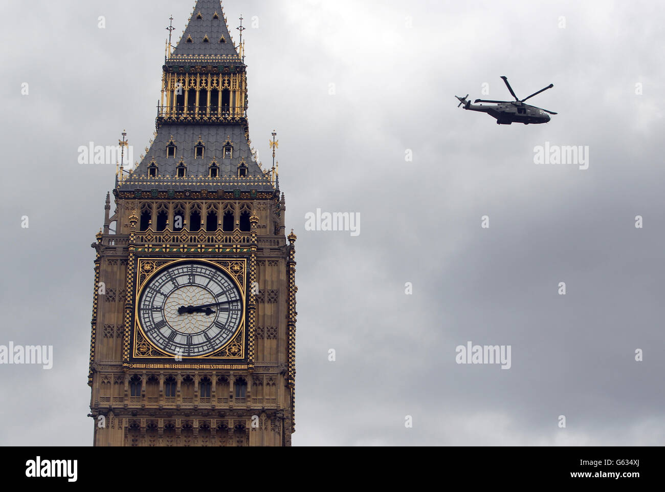 A Merlin Helicopter flies over Big Ben in Central London Stock Photo