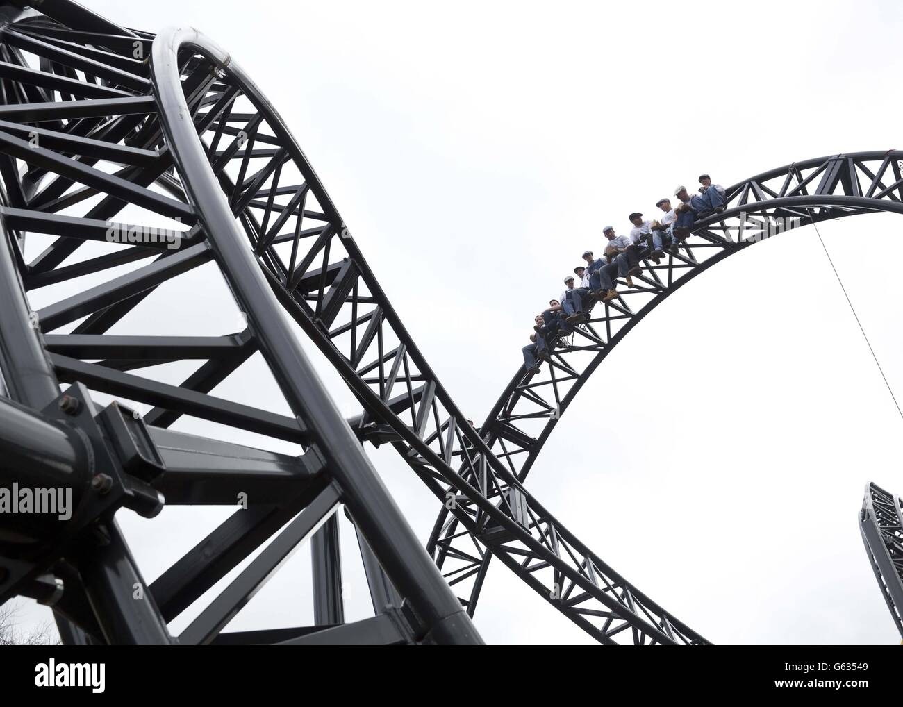 Workmen from Alton Towers Resort in Staffordshire, celebrated the completion of the new worlds-first highest roller coaster, The Smiler, by creating a modern-day version of the famous Lunch atop a Skyscraper shot from 1932. Stock Photo