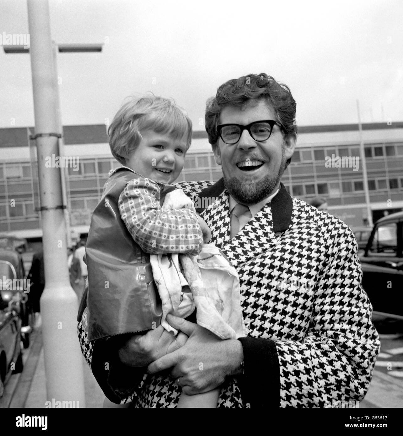 Australian entertainer Rolf Harris with his three-year-old daughter Bindi at Heathrow Airport. They arrived back from Canada, bringing an Eskimo doll from Montreal's Expo '67. Stock Photo
