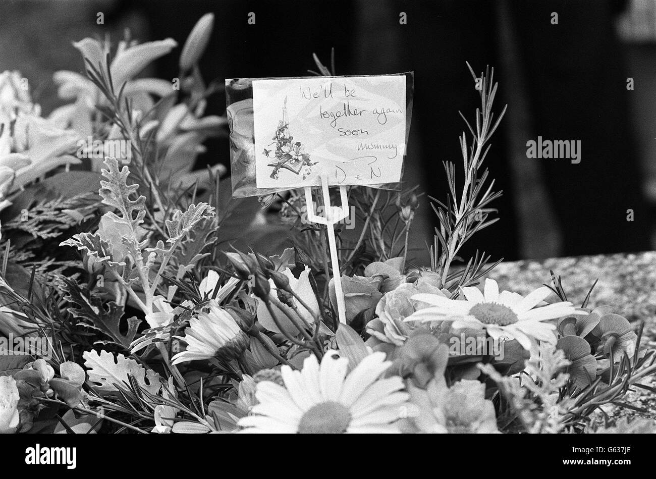 A wreath marked with 'We'll be together again soon, Mummy' signed with the initials of twins Daniel and Nicholas Caffell, who died with their mother and her parents in the Essex farmhouse massacre. Stock Photo