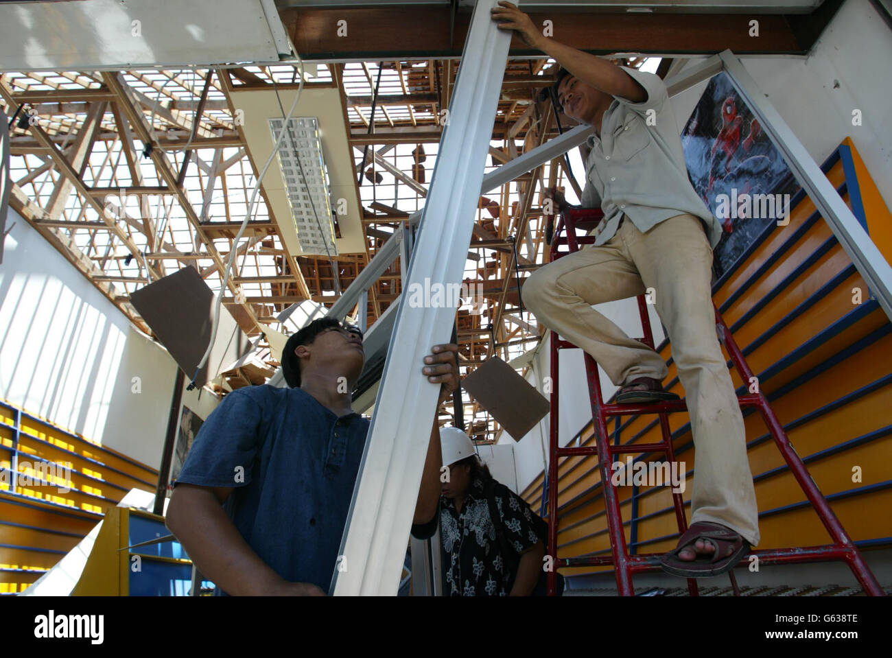 Shopkeepers remove debris as the rebuilding process begins near the Sari Club in Kuta, Bali following the car bomb attack at the club in the town. * Australian Prime Minister John Howard was due in Bali amid growing anger over claims his government failed to act on intelligence warnings of terrorist threats to Asian tourist spots ahead of the attack in which up to 200 people died, including around 30 Britons. Stock Photo