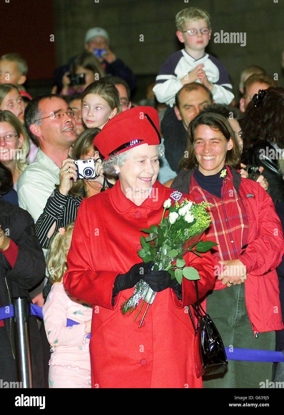 Queen Elizabeth II leaves the crowds with a bouquet of flowers she received during her visit to the new Darwin Centre, at the Natural History Museum, London. The Queen was visiting the 30 million Centre for its official opening. Stock Photo