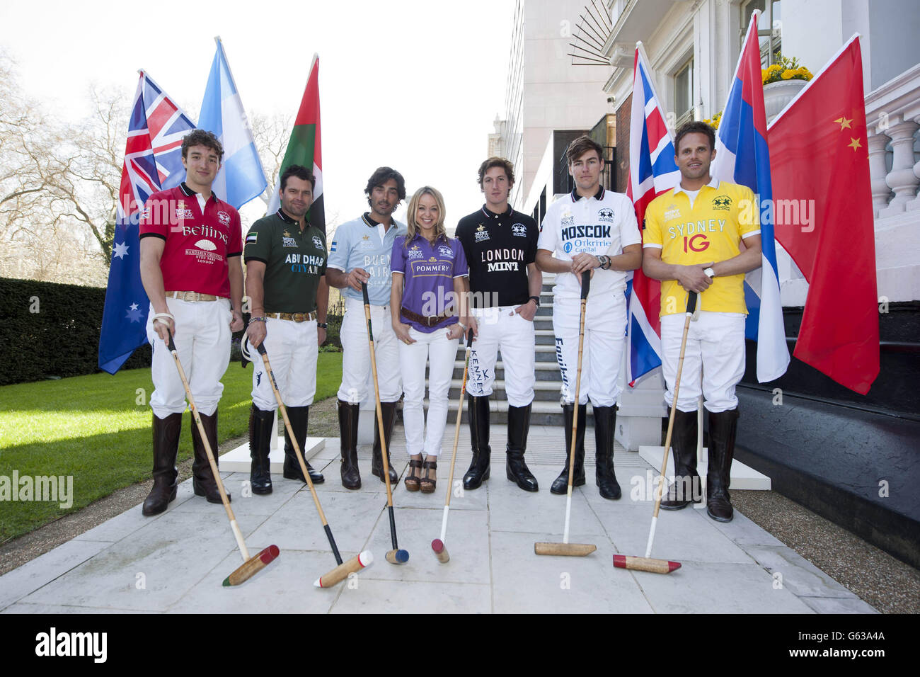 EDITORIAL USE ONLY: Television presenter Abi Griffiths with representatives of each competing team (Left to right) Dougie Le Ber-Smith, Mandarin Oriental Hyde Park Team Beijing, Nacho Gonzales, City AM Team Abu Dhabi, Oscar Mancini, Camino Real Buenos Aires, George Meyrick, MINT Team London, Max Charlton, Okritie Team Moscow and Jamie Morrison, IG Index Team Sydney at the launch of the MINT Polo in the Park 2013 event at The Mandarin Oriental Hotel Hyde Park in London. Stock Photo