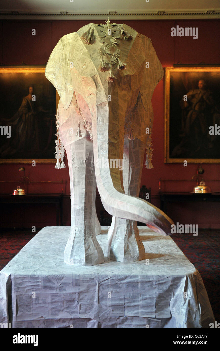 The Elephant in the Room, a 12ft sculpture of an Indian Elephant by Ballet Rambert production designer, Michael Howells, and finished in paperback book pages, in the Big Dining Room at the Port Eliot stately home in St Germans, Cornwall. Stock Photo