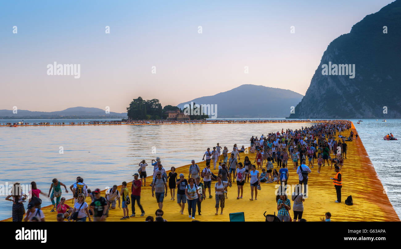 The Floating Piers Christo project. Visitors walking from Sulzano to Monte Isola and to the island of San Paolo. Stock Photo