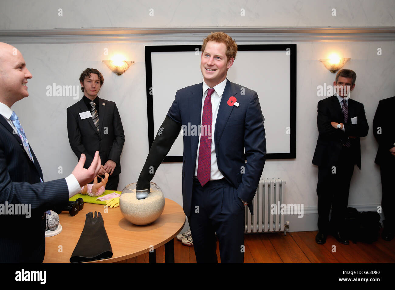 Prince Harry wears a glove to experience what it is like to have a brain injury as he opens the new headquarters of Headway, the brain injury charity during an official visit to Nottingham. Stock Photo