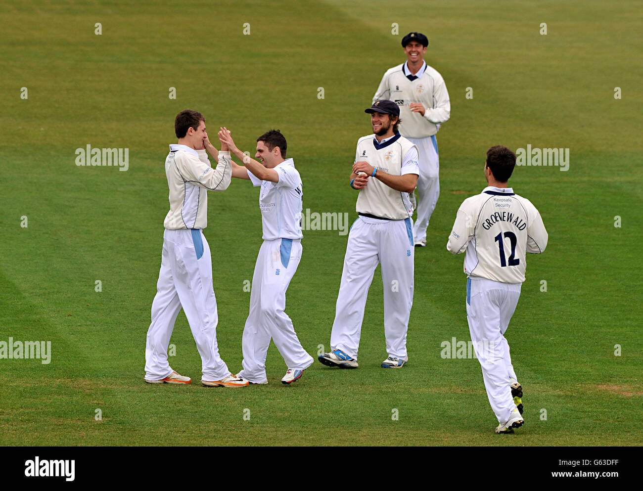 Derbyshire's David Wainwright (centre left) celebrates taking the wicket of Nottinghamshire's Ed Cowan, caught by Derbyshire's Greg Cork (left) during the LV= County Championship, Division One match at the County Ground, Derby. Stock Photo