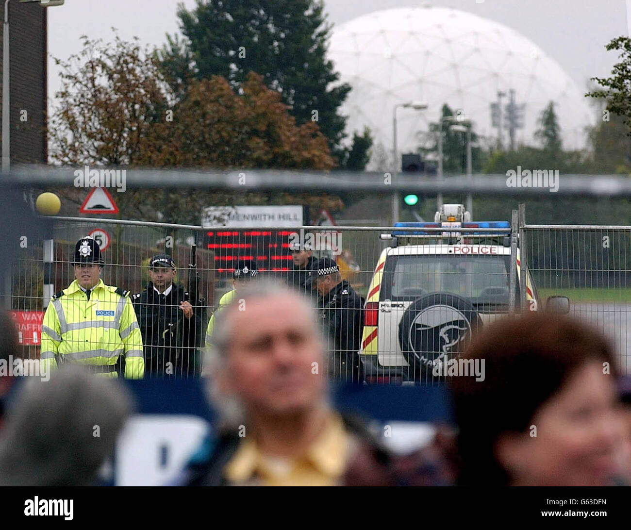 Armed police on guard at the USAF Base at Menwith Hill near Harrogate, where a demonstration against war in Iraq was being held. The base, which is owned by the Ministry of Defence (MoD), is made available to the US Department of Defense (DoD). *... and provides intelligence support for UK, US and NATO interests. It is also the site for the European Relay Ground Station (RGS-E) that is part of the US space-based lnfra-Red System (SBIRS) designed to detect infra-red targets, such as a missile launch. Stock Photo