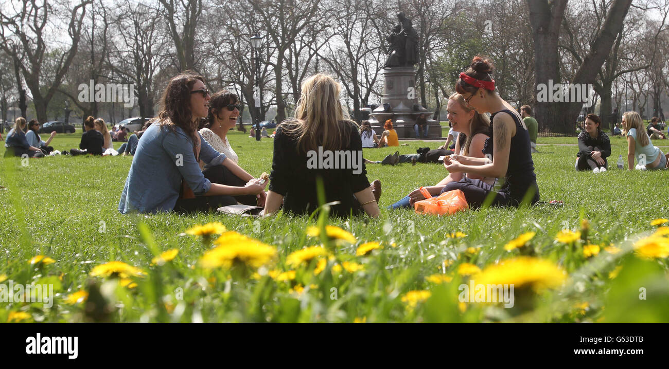 People enjoy the hot weather on Clapham Common in London after parts of