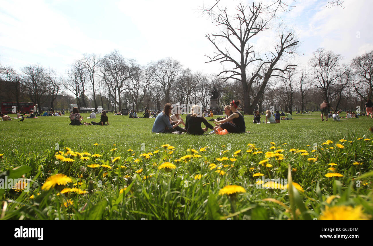 People enjoy the hot weather on Clapham Common in London after parts of