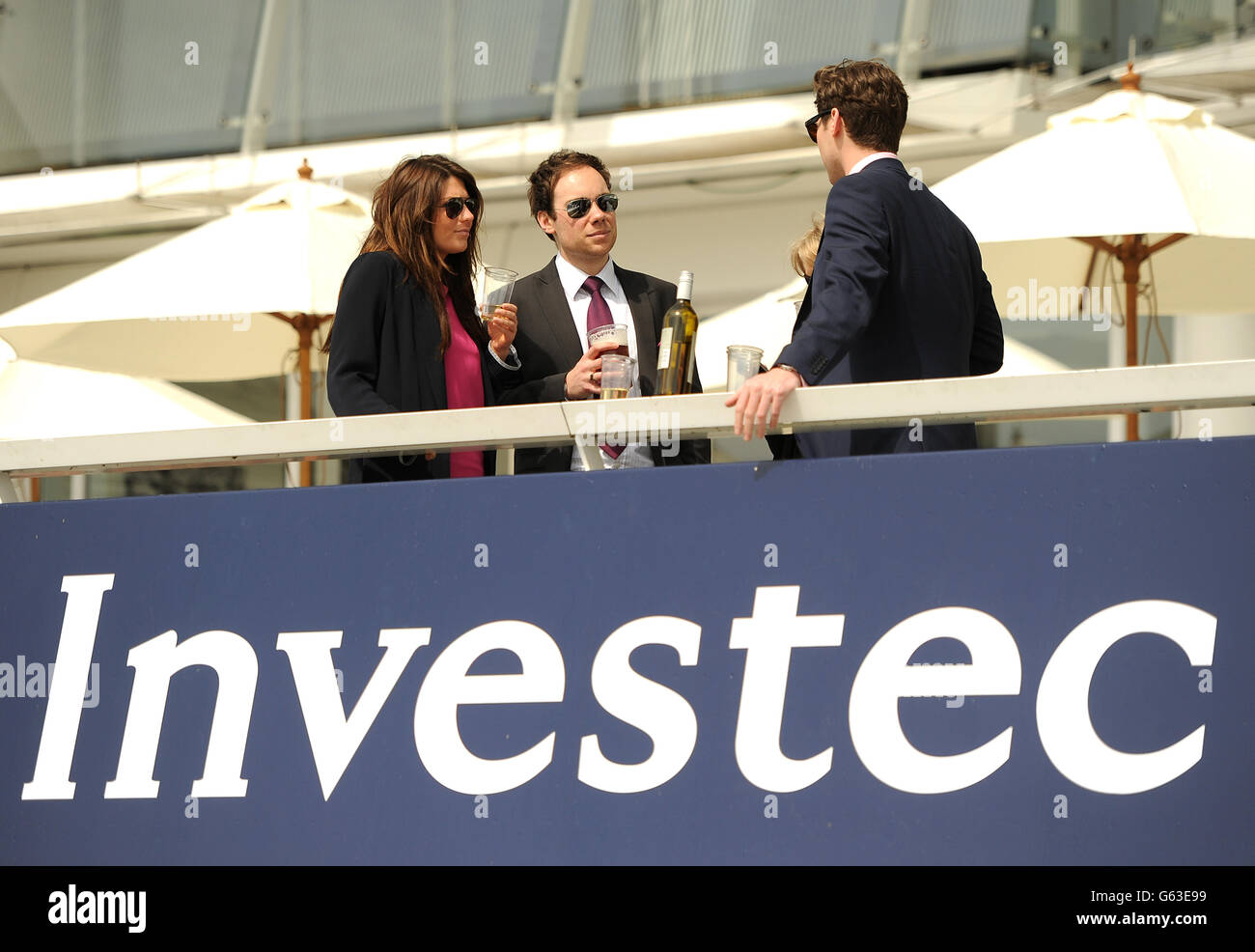 Horse Racing - Investec Spring Meeting - Epsom Downs Racecourse. Racegoers enjoy the action from the grandstand Stock Photo