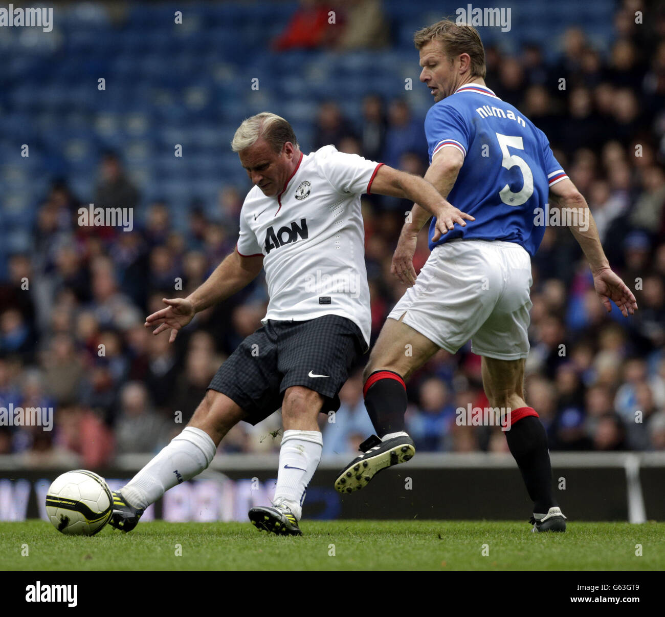 Manchester United's Clayton Blackmore (left) and Rangers Arthur Numan fight for the ball during the legends match at Ibrox Stadium, Glasgow. Stock Photo