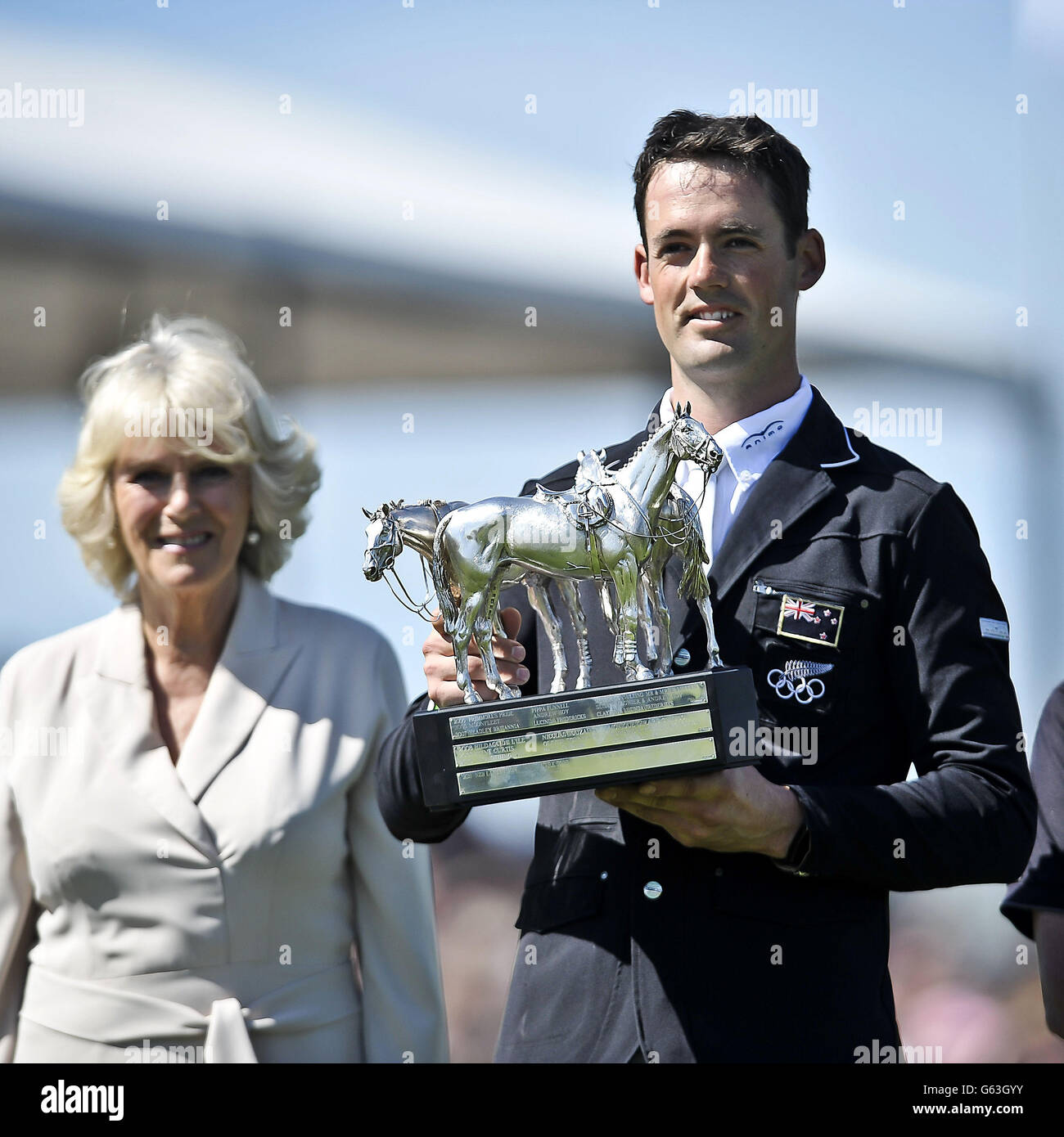 Badminton Horse Trials winner 2013 New Zealand's Jonathan Paget with his trophy presented by Her Royal Highness the Duchess of Cornwall during day five of the Badminton Horse Trials in Badminton, Gloucestershire. Stock Photo