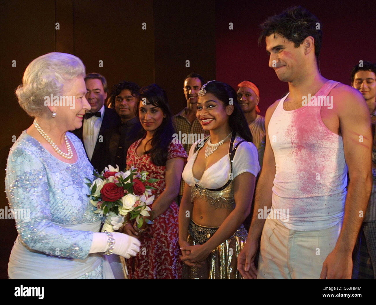 Queen Elizabeth II greets members of the cast at a charity performance of the musical 'Bombay Dreams' in London. The Gala evening is being held on behalf of the Red Cross. * The cast members are from left to right, Preeya Kalidas who plays Priya, Ayesha Dharker-Rani, and Raza Jaffrey -Akaash. Stock Photo