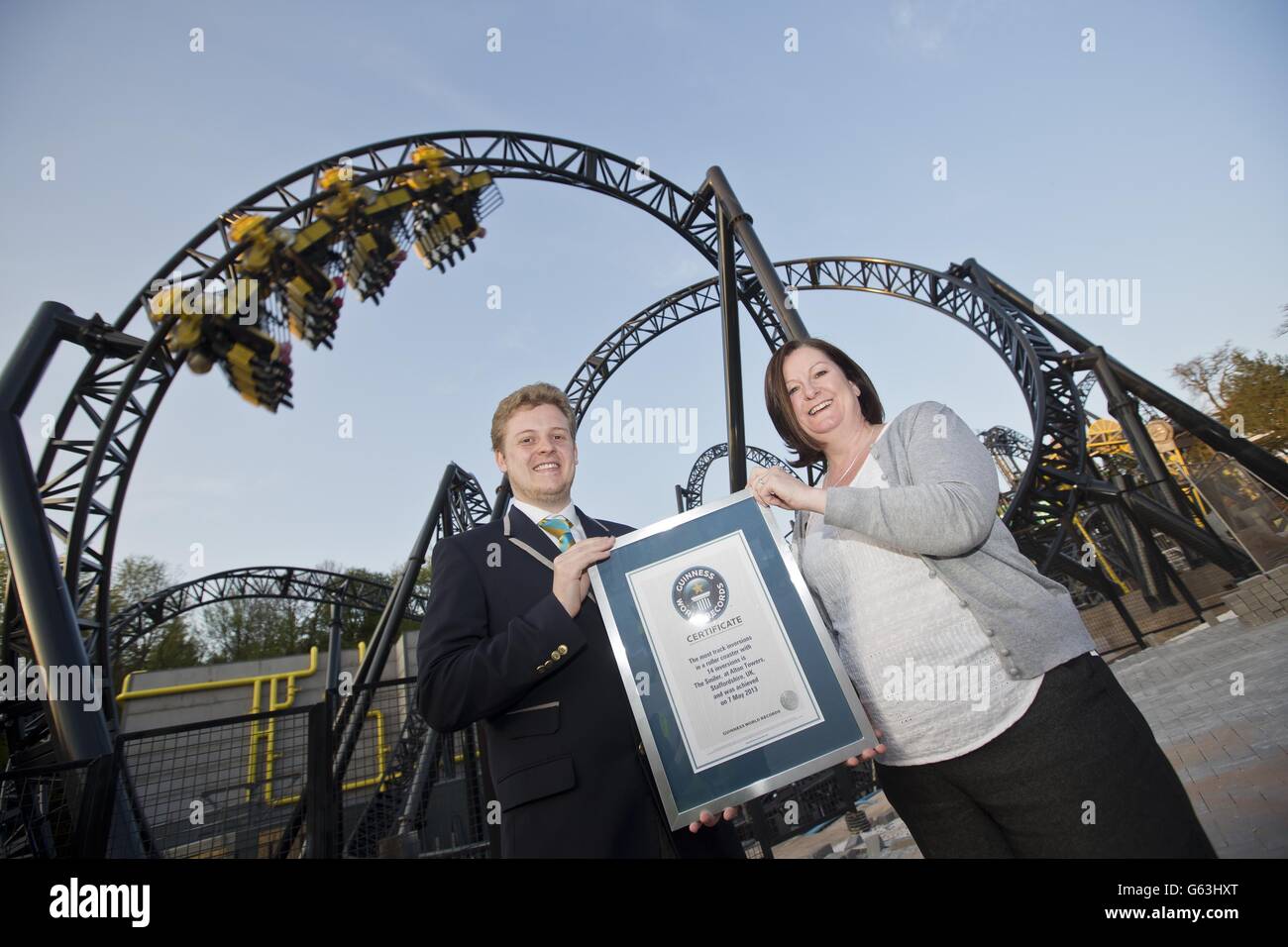 Tom Ibison, Guinness World Record (GWR) Adjudicator and Katherine Duckworth&Ecirc;Head of Consumer Marketing&Ecirc;at the Alton Towers Resort in Staffordshire celebrate the Resort setting a new Guinness World Record for the most inversions during the unveiling of The Smiler, the world's first 14-looped rollercoaster, which opens to the public on 18th May 2013. Stock Photo