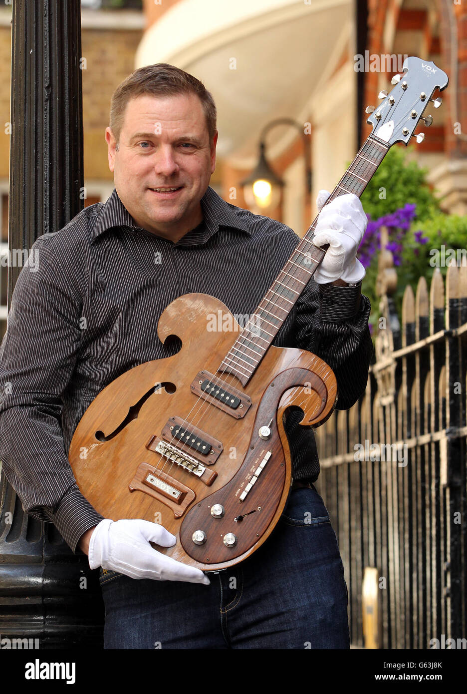 Darren Julien President and CEO of Julien's Auctions with a rare VOX guitar played by George Harrison and John Lennon during The Beatles 1967 Magical Mystery Tour. Stock Photo
