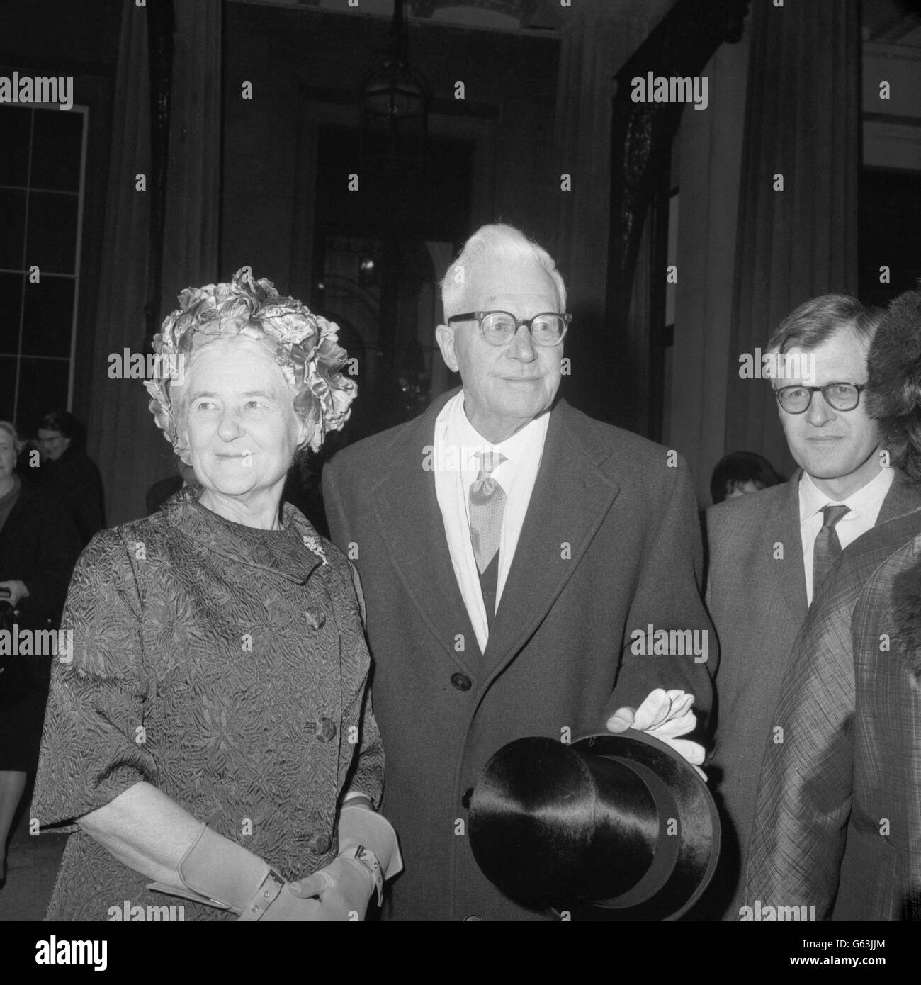 After receiving the honour of Knighthood from the Queen at Buckingham Palace, Sir Barnes Wallis with Lady Wallis outside the palace. He was made a Knight Bachelor in the Birthday Honours List, 25 years after his greatest achievement - the invention of the bouncing bomb used by the Dam Busters in the Second World War. Stock Photo