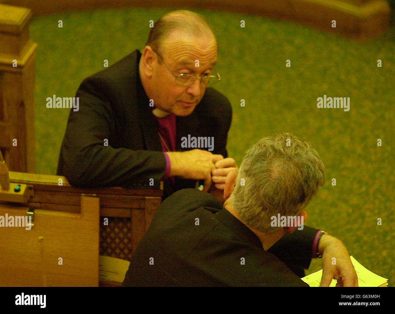 The Archbishop of York, David Hope (left) talks during a meeting of the Church Synod, at Church House, Westminster, London, to debate the prospect of conflict with Iraq after its House of Bishops recently warned that the outcome in terms of suffering on all sides could be immense. Stock Photo