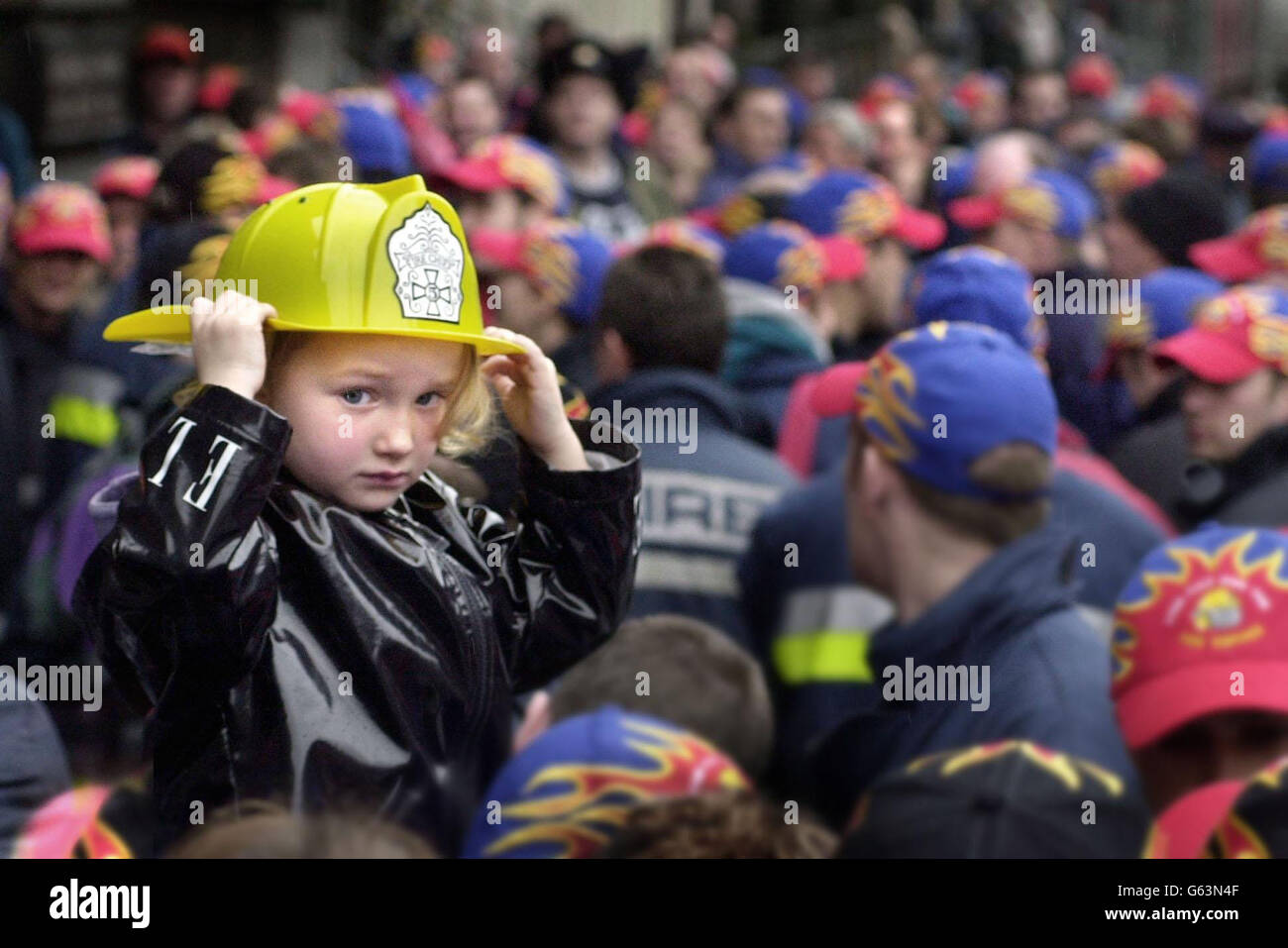 Firefighters gather for a meeting in Edinburgh with Andy Gilchrist, general secretary of the FBU. Eva Silverstone, 3, from Edinburgh is held up above the crowd. Stock Photo