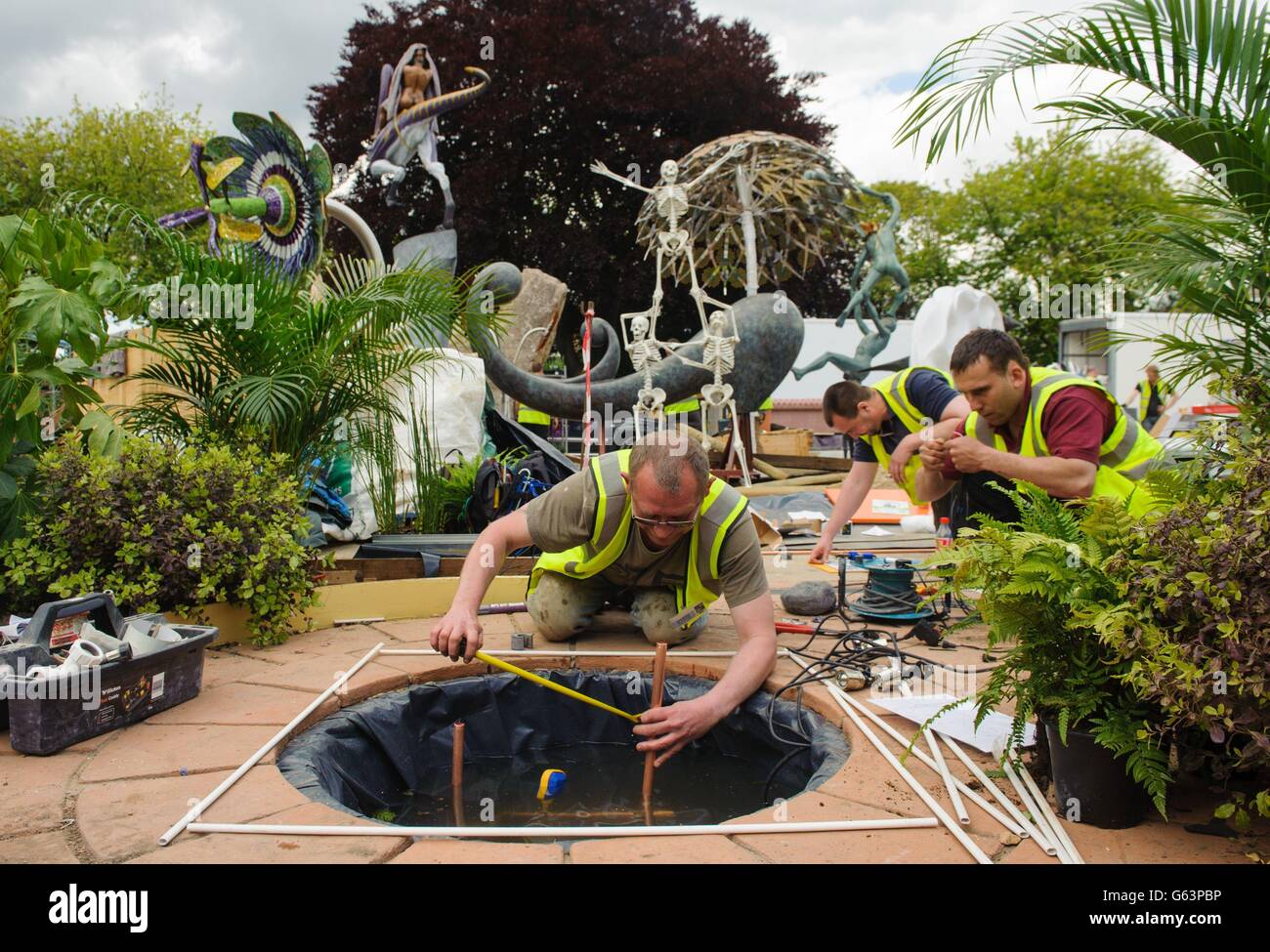 Workers prepare the Aqua Innovations garden at the RHS Chelsea Flower Show, which opens to the public from May 21 to May 25 2013. Stock Photo