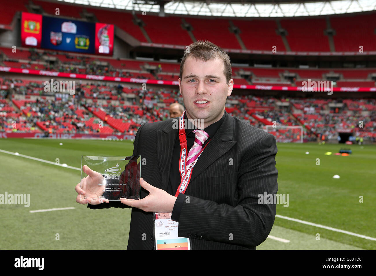 Soccer - npower Football League One - Play Off - Final - Brentford v Yeovil Town - Wembley Stadium. A member of staff at Oxford United FC accepts the award for League 2 Programme of the year on the pitch Stock Photo