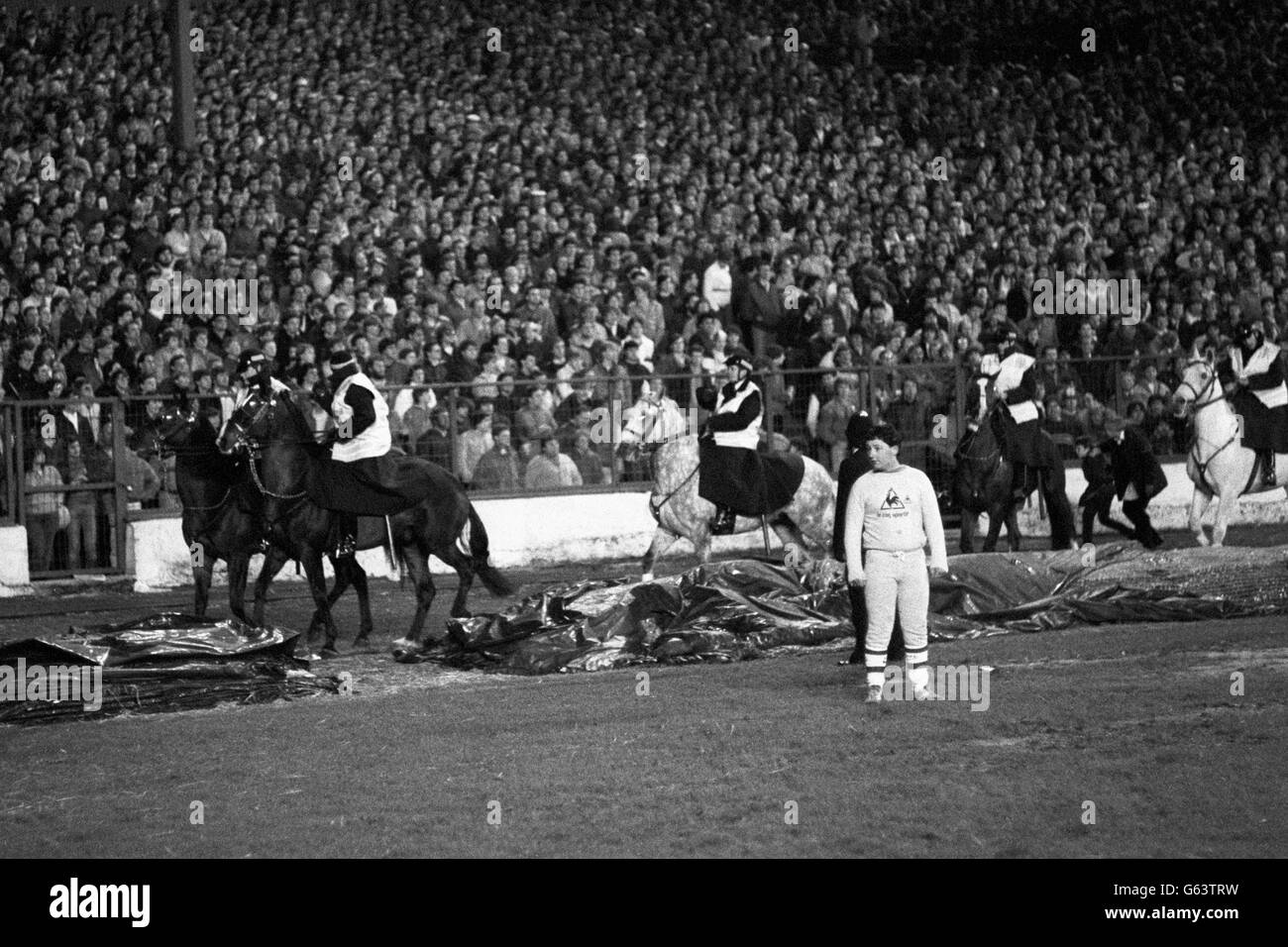 Chelsea fans invade the pitch during Chelsea versus Sunderland Milk Cup semi-final, second leg game at Stamford Bridge, London, where Sunderland won 3-2. The game was held up for six minutes because of pitch invasions. Mounted police are shown trying to bring order to the pitch. Six policemen were injured and 23 other people taken to hospital, and approximately 100 arrested. Stock Photo