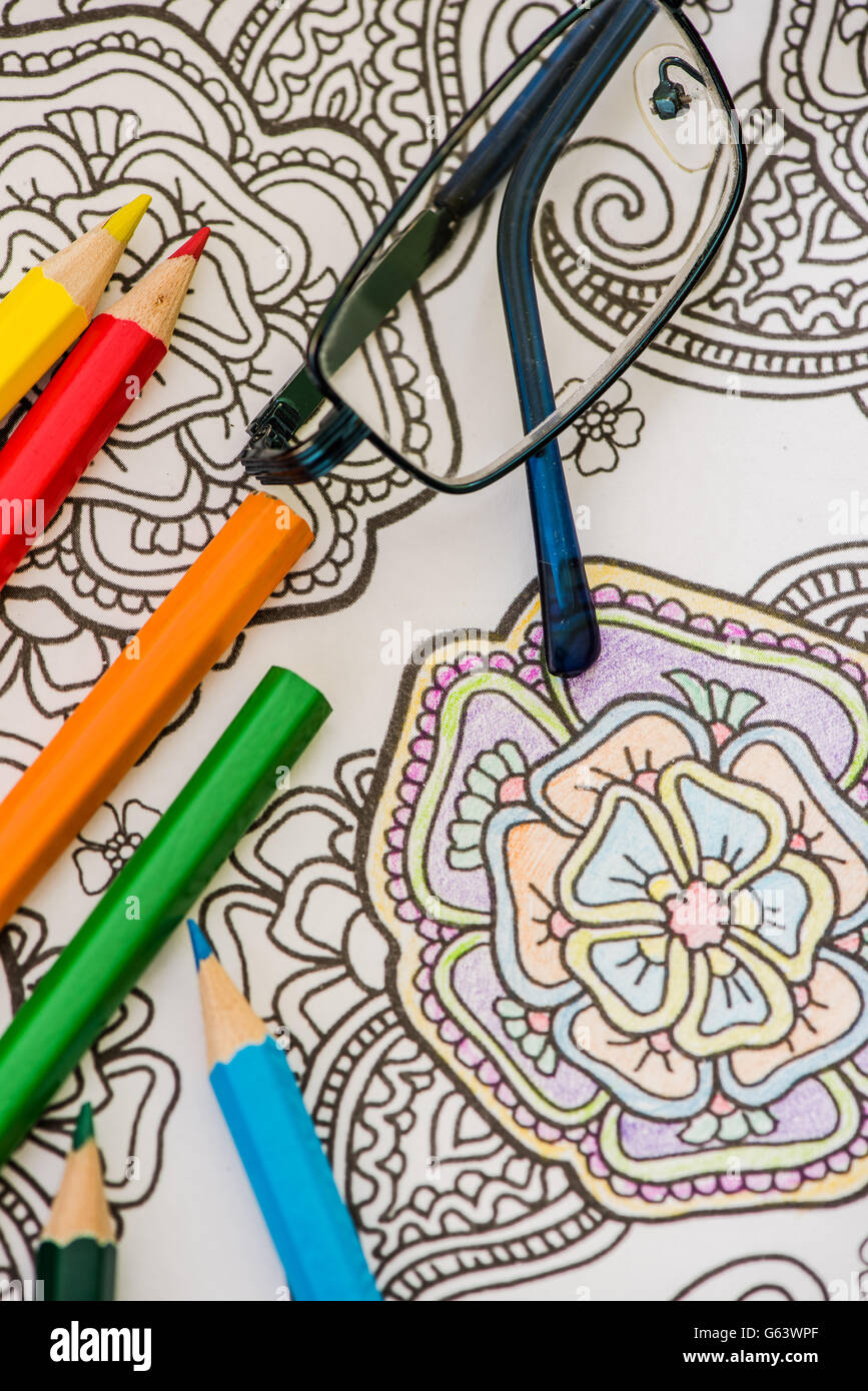 adult coloring book and colorful pencils, relaxation concept Stock Photo