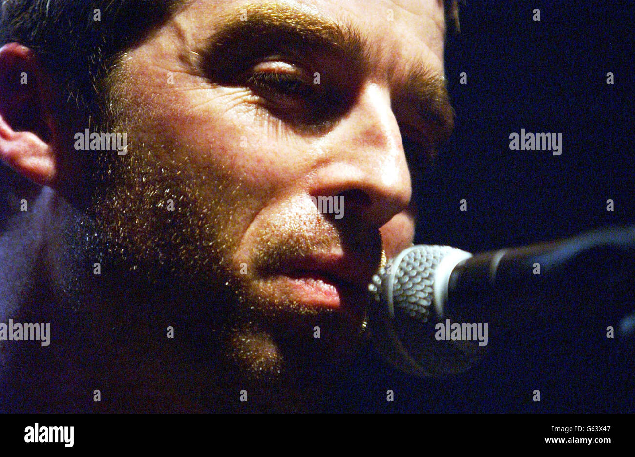 Oasis's Noel Gallagher performing on stage during a concert given in aid of Oxfam's 'Make Trade Fair' campaign at the Astoria Nightclub in central London. Stock Photo